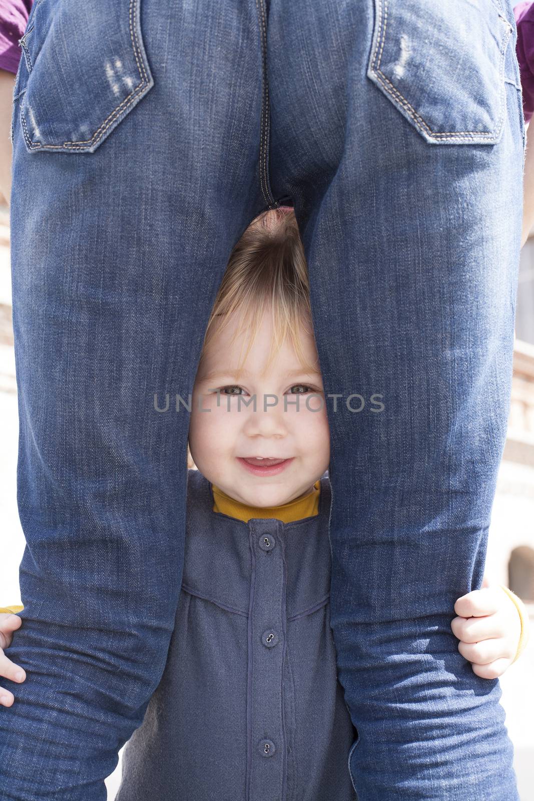 baby looking between mother legs by quintanilla