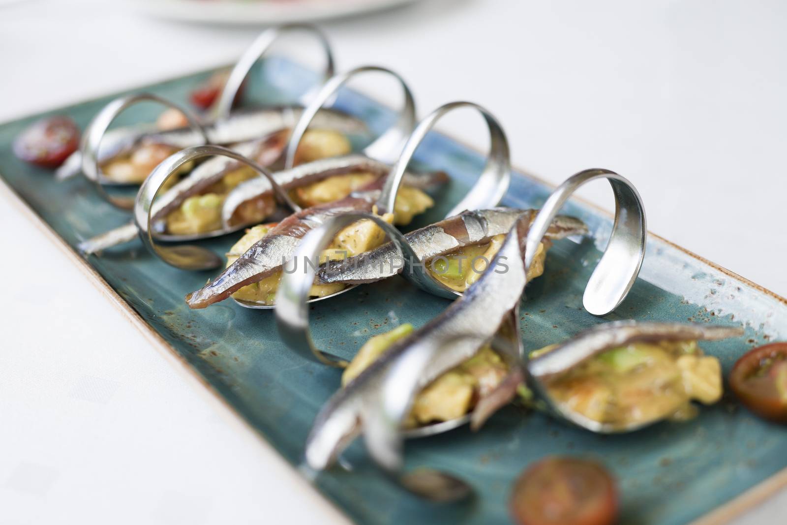 closeup anchovies with guacamole by quintanilla