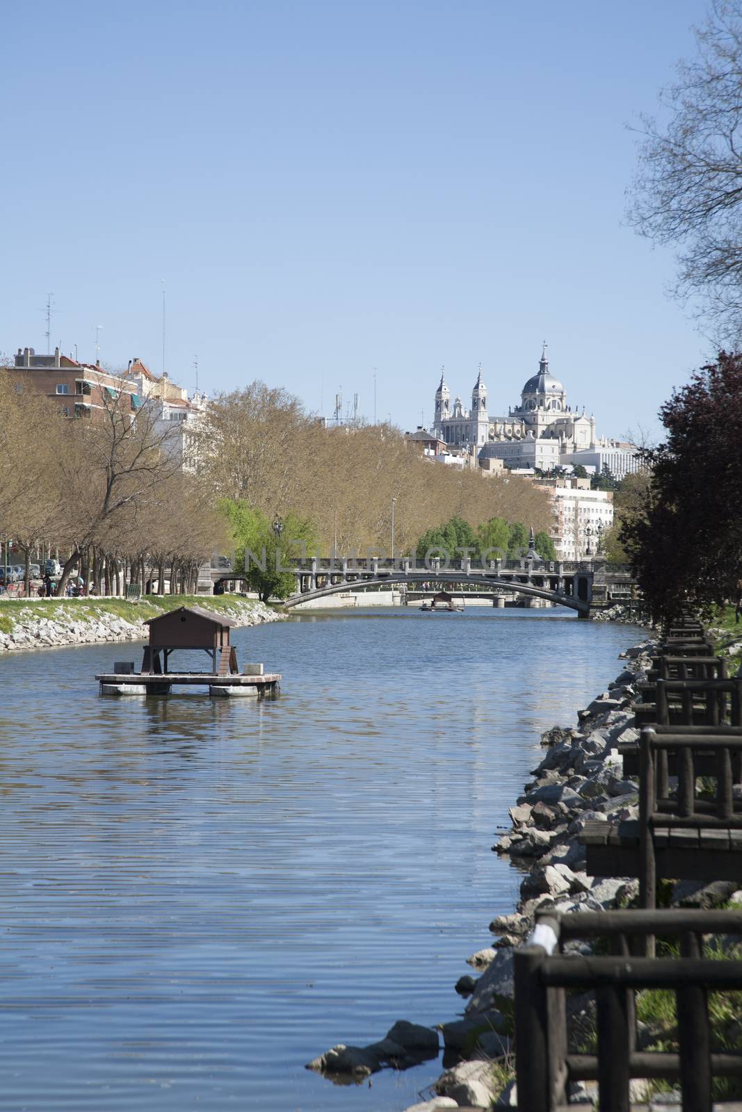 landmark of Madrid city with Almudena cathedral from Manzanares river blue water in Spain Europe