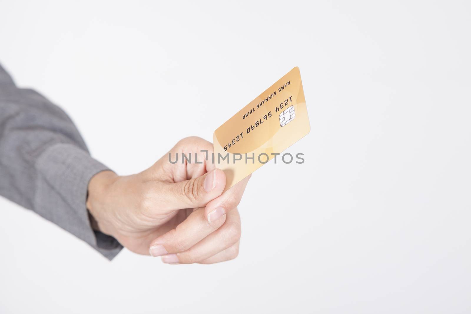 woman blue jeans trousers and grey shirt offering made up fiction credit card in her hands isolated over white background