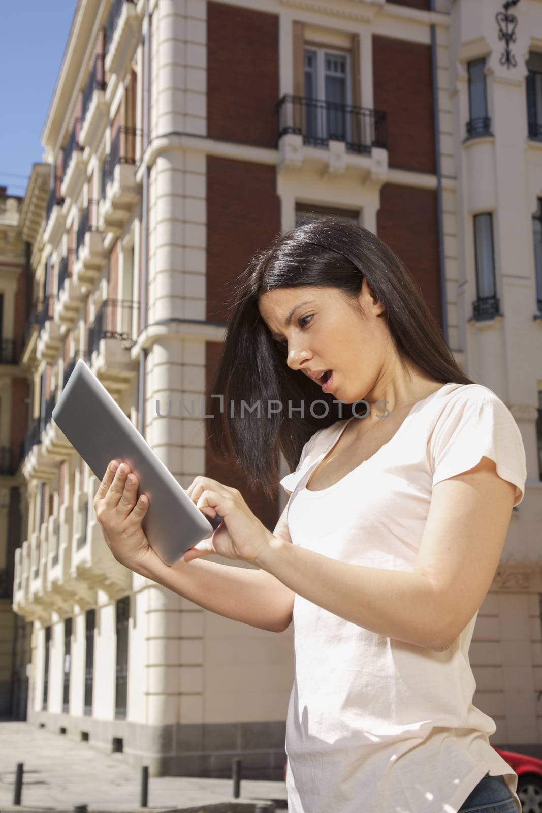 woman watching digital tablet by quintanilla