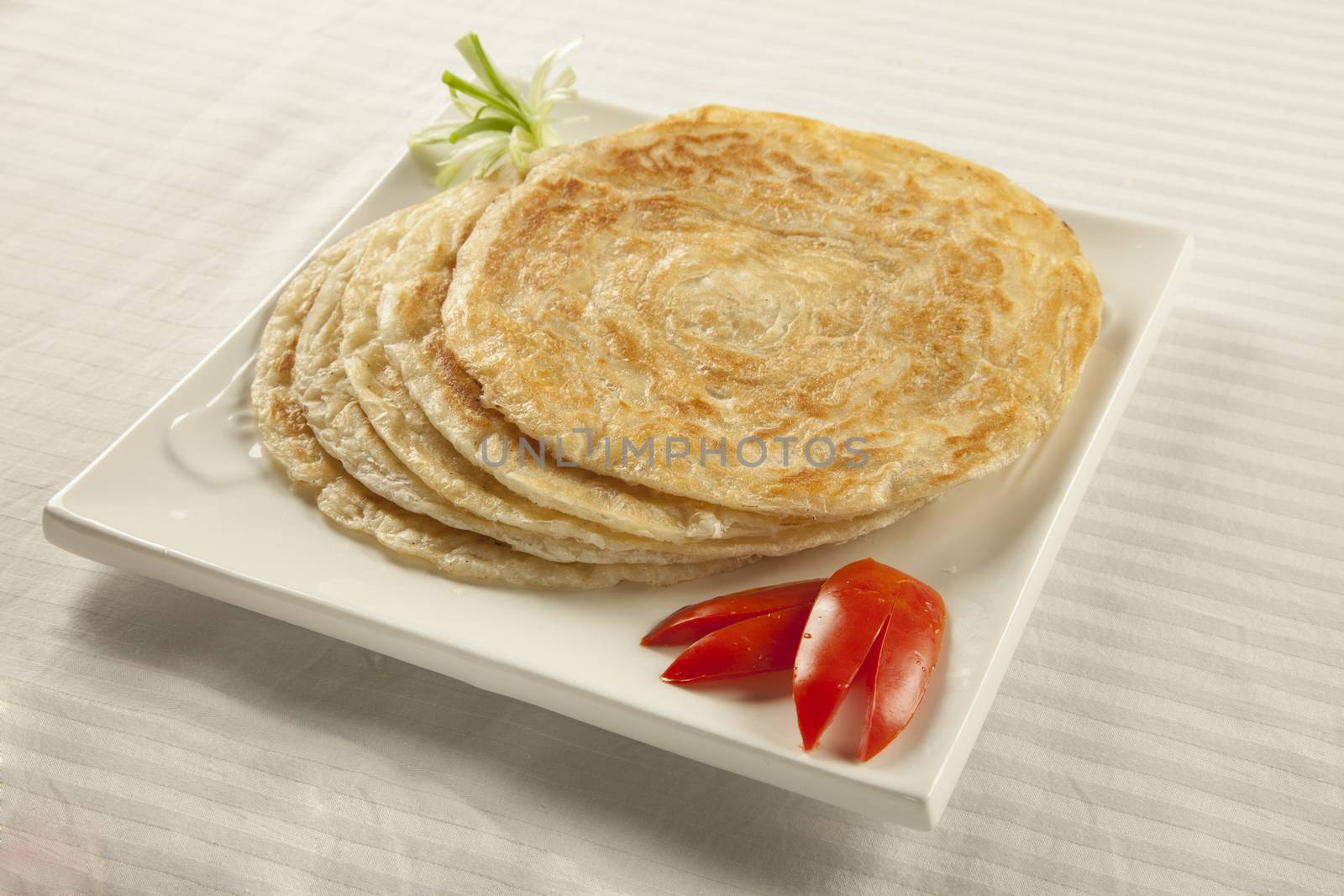 Plain paratha puri served with freshly sliced tomato and cucumbe by haiderazim