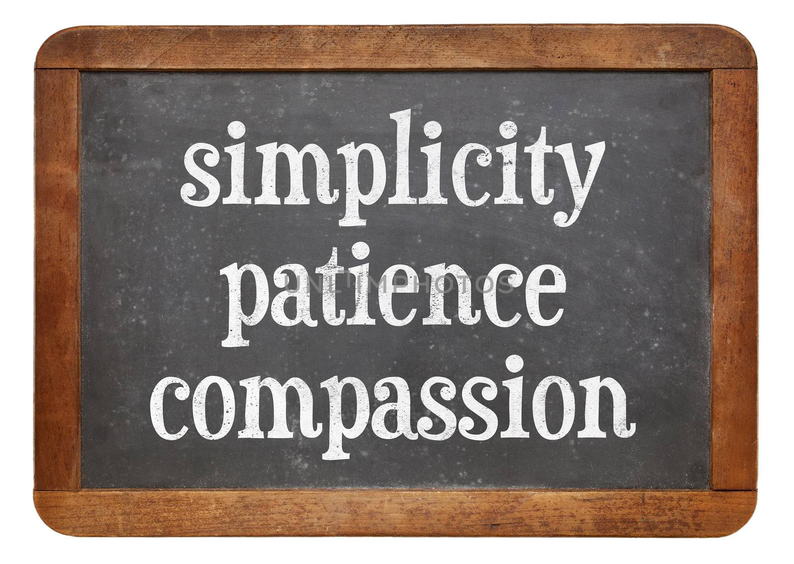 Simplicity, patience and compassion - three words from Buddha teaching on a vintage slate blackboard