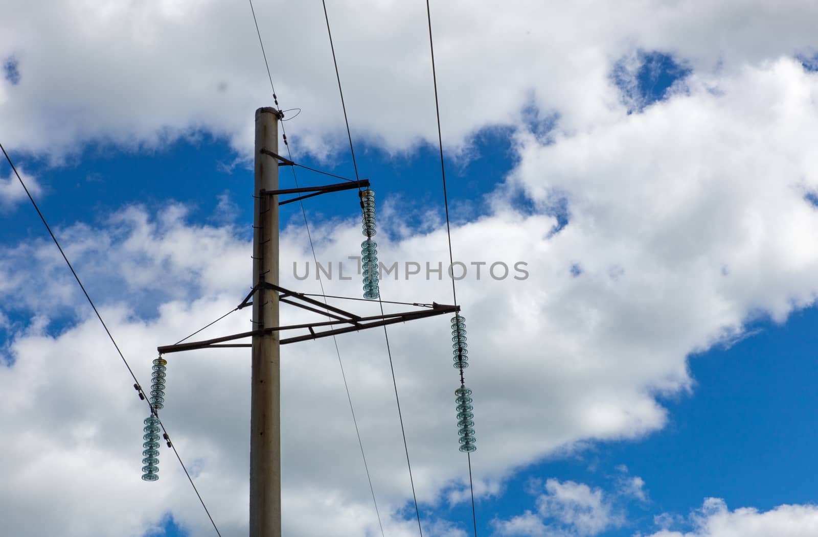 Garlands of insulators on blue sky background