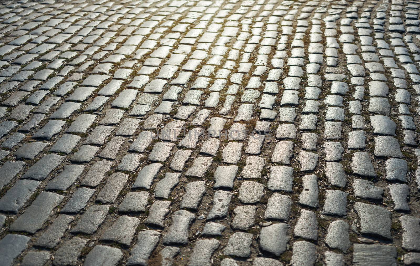 cobbled road as background on sunset