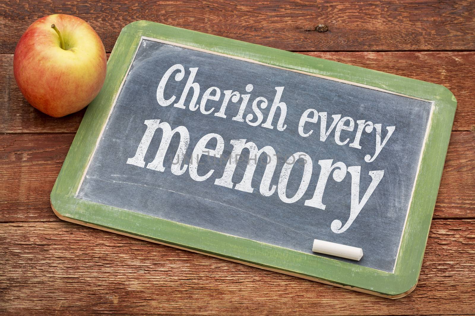 Cherish every memory  - inspirational words  on a slate blackboard against red barn wood