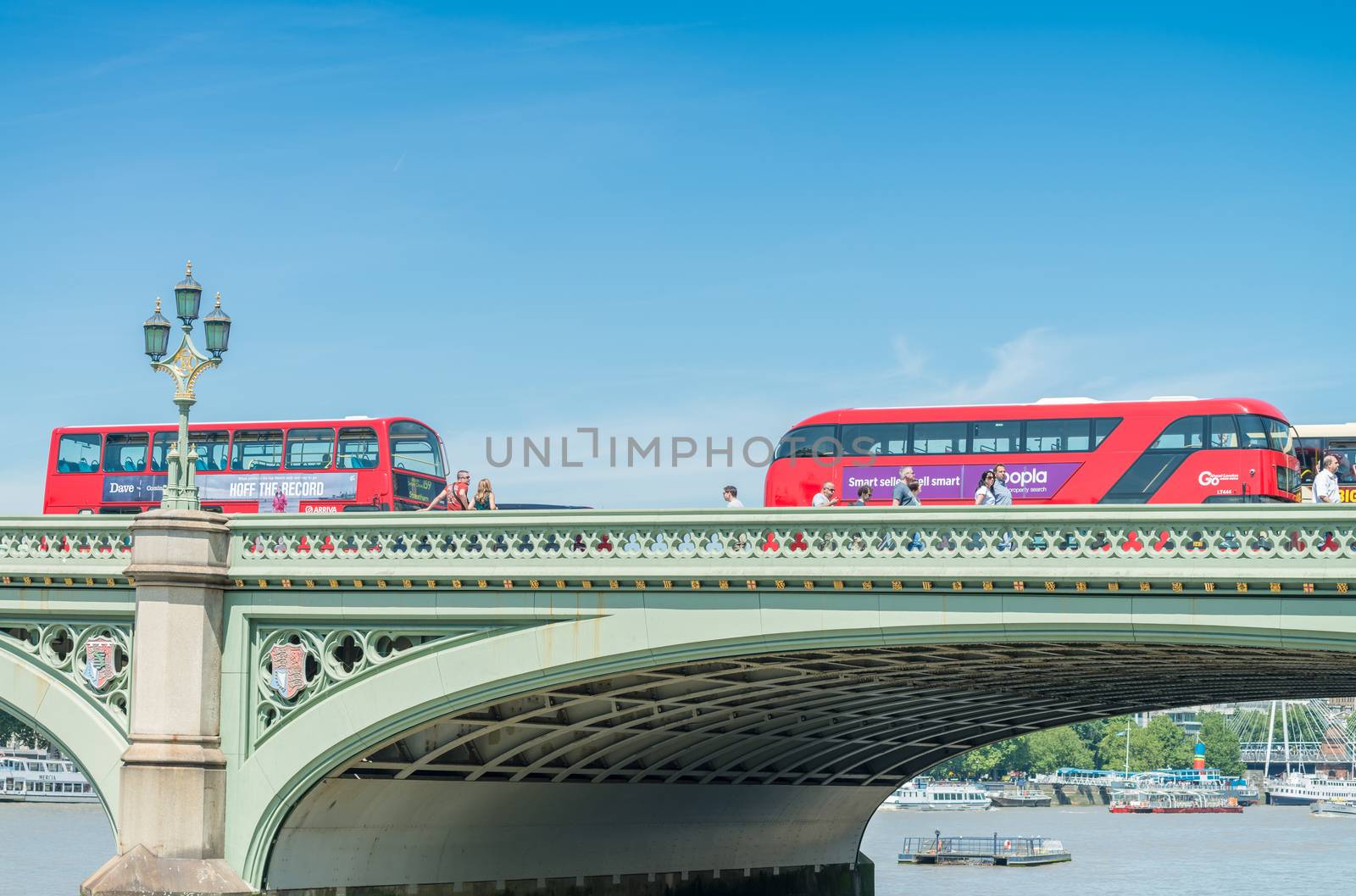 LONDON - JUNE 15, 2015: Traffic and tourists along Westminster B by jovannig