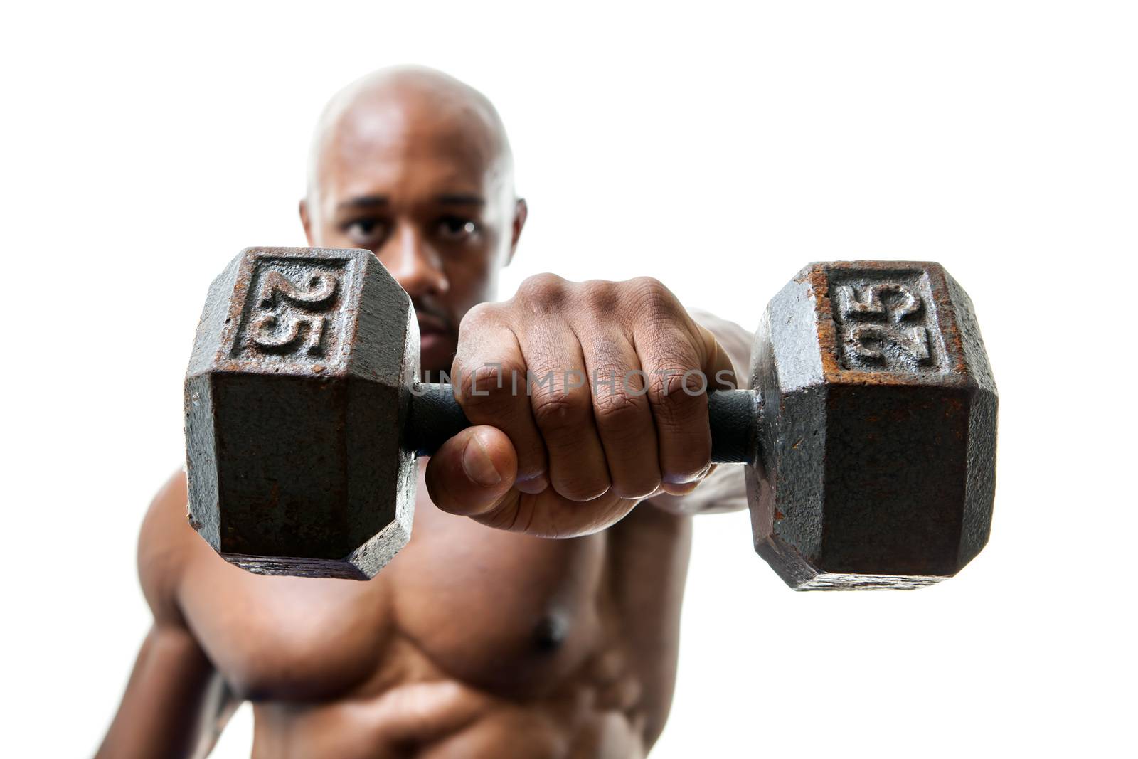 Toned and ripped lean muscle fitness man lifting weights isolated over a white background. Shallow depth of field.