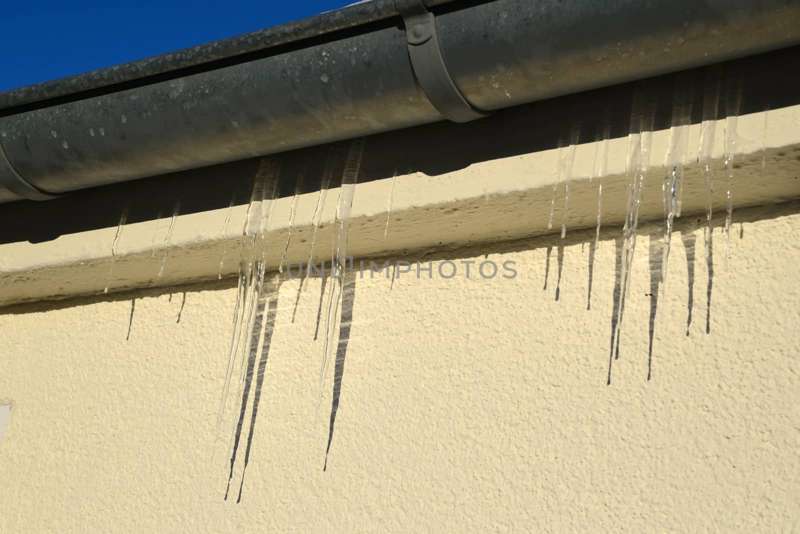 Icicles on a water pipe by dk_photos