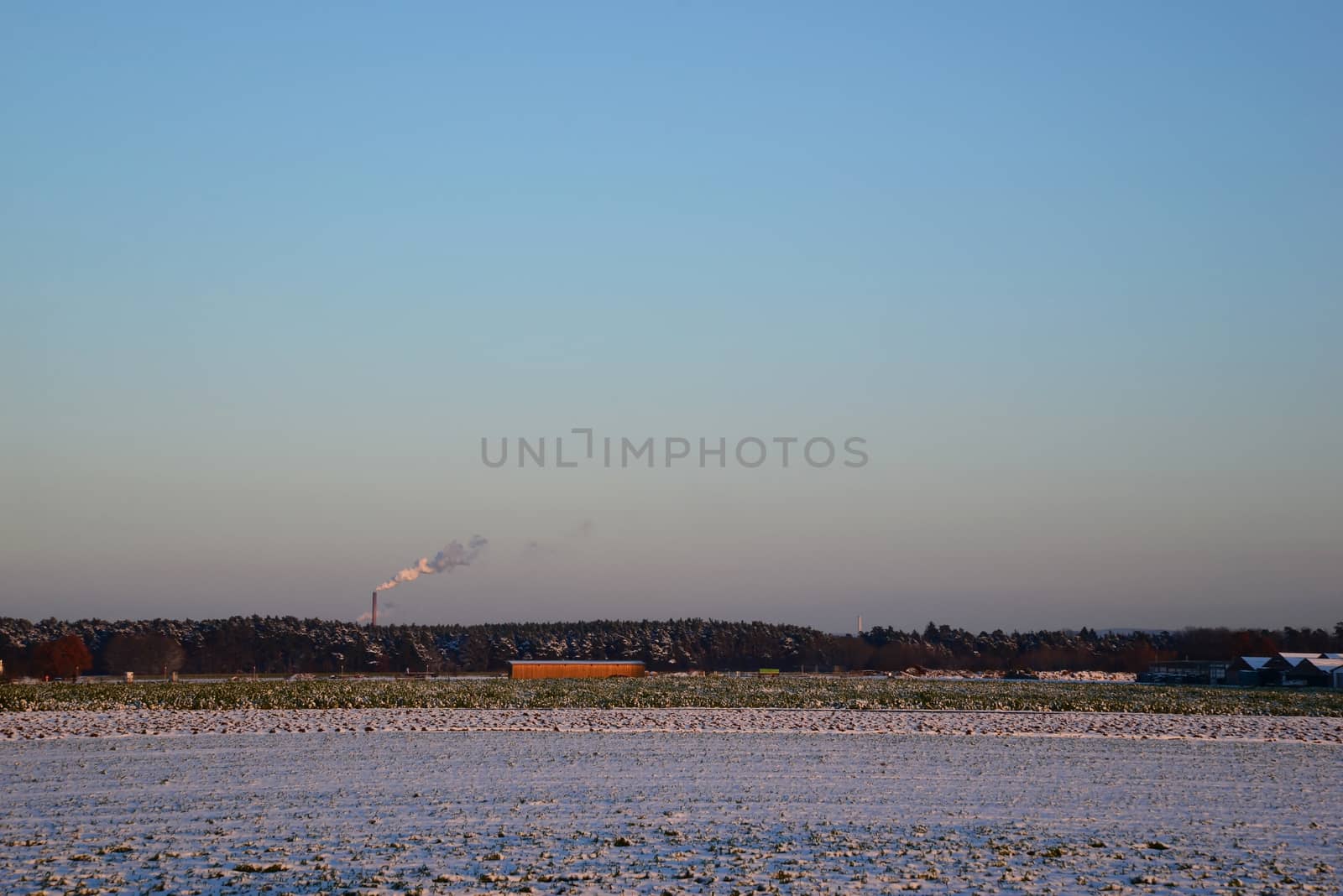 Photo of industrial smoke from a chimney during winter time. Illustration of industrial pollution, environmental problems.
Taken in Germany.