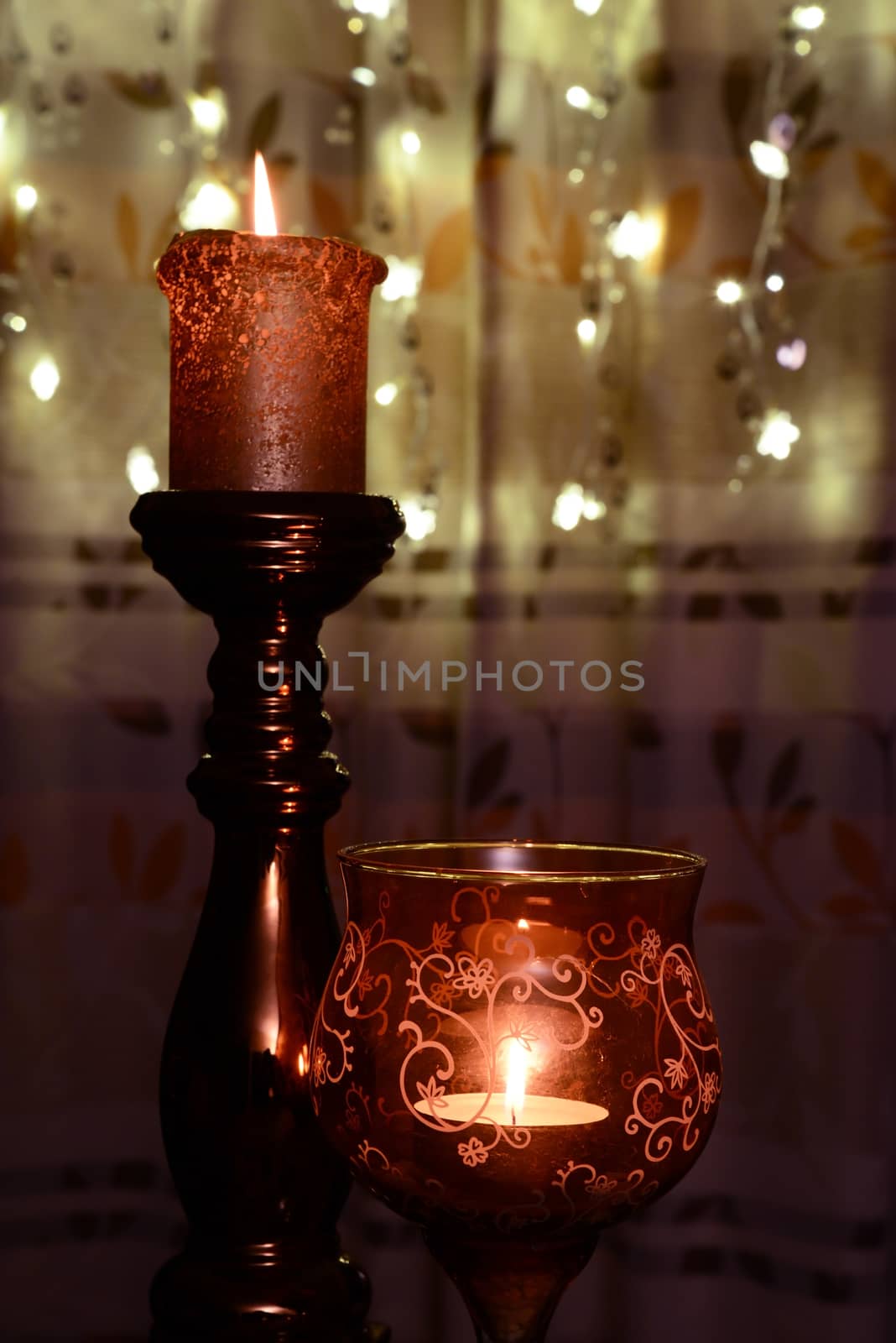 Two orange candles over christmas lights by dk_photos