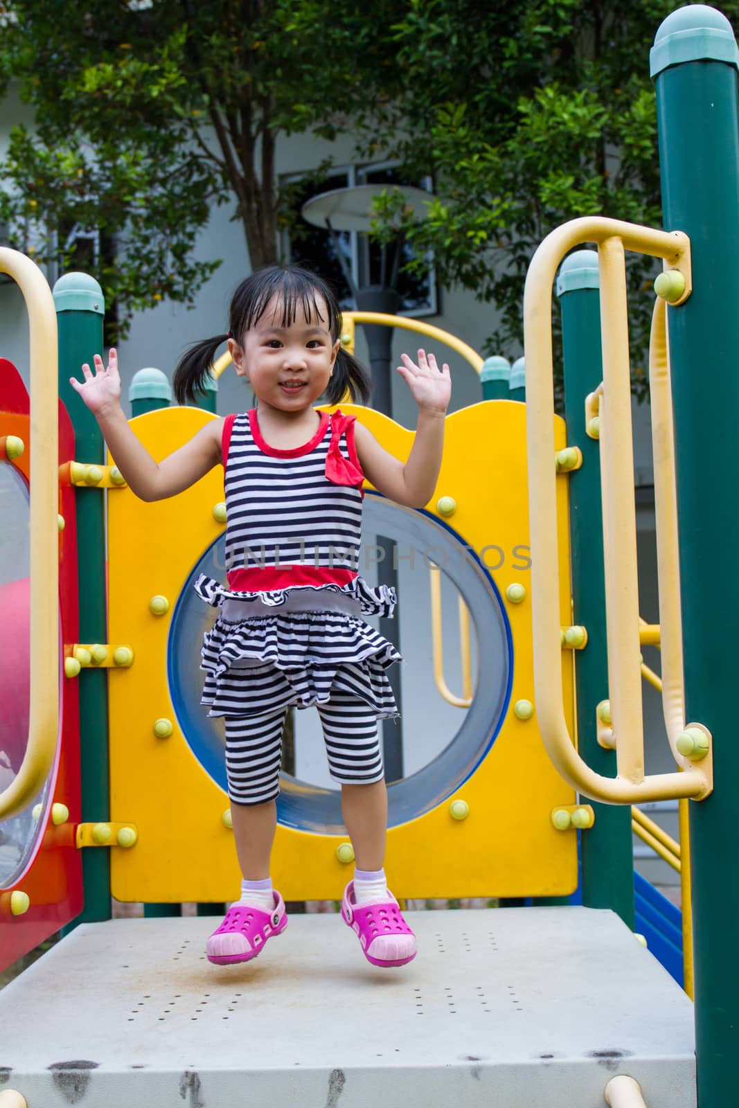 Asian Chinese little girl playing on Playground