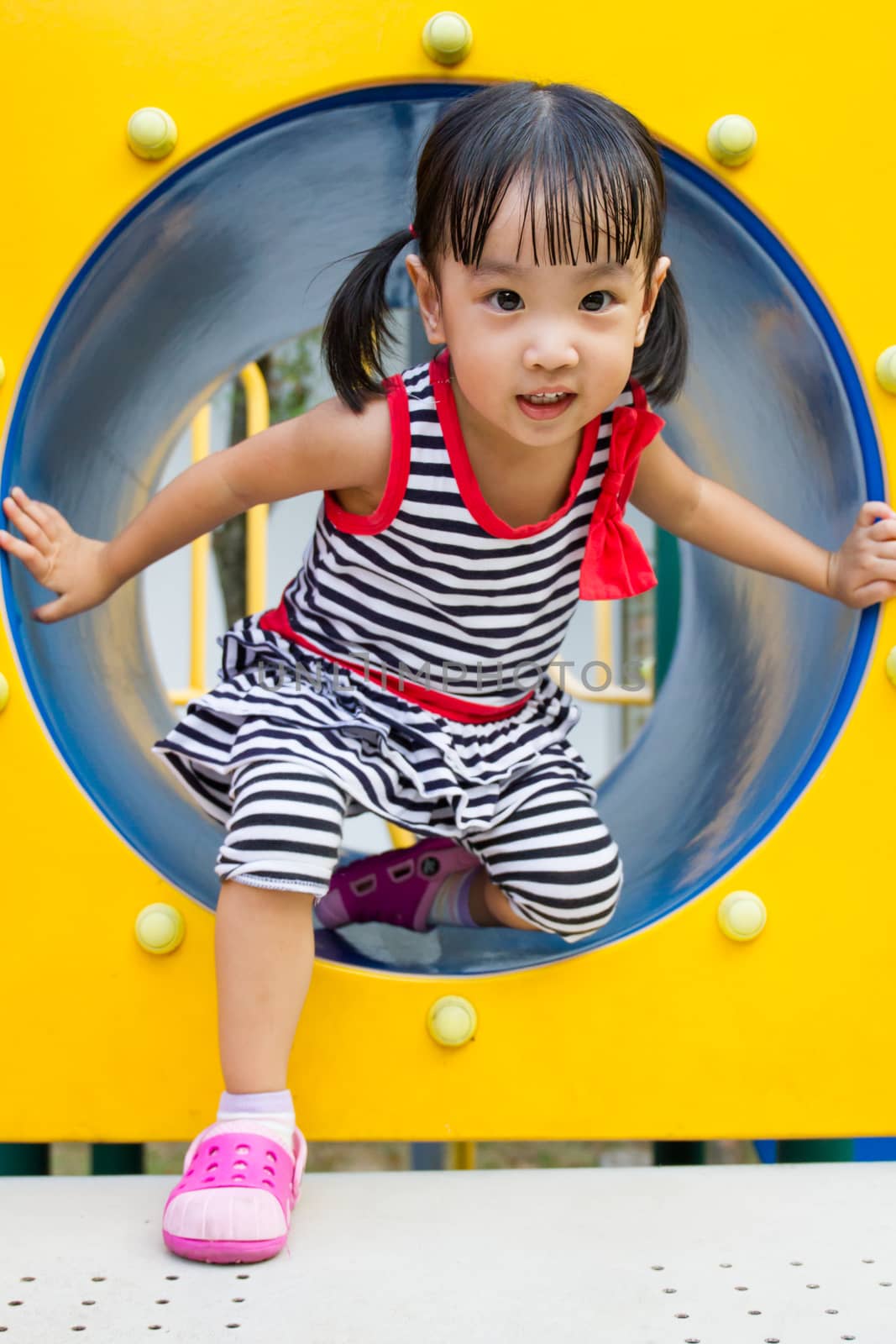 Asian Kid Crawling on Playground Tube by kiankhoon