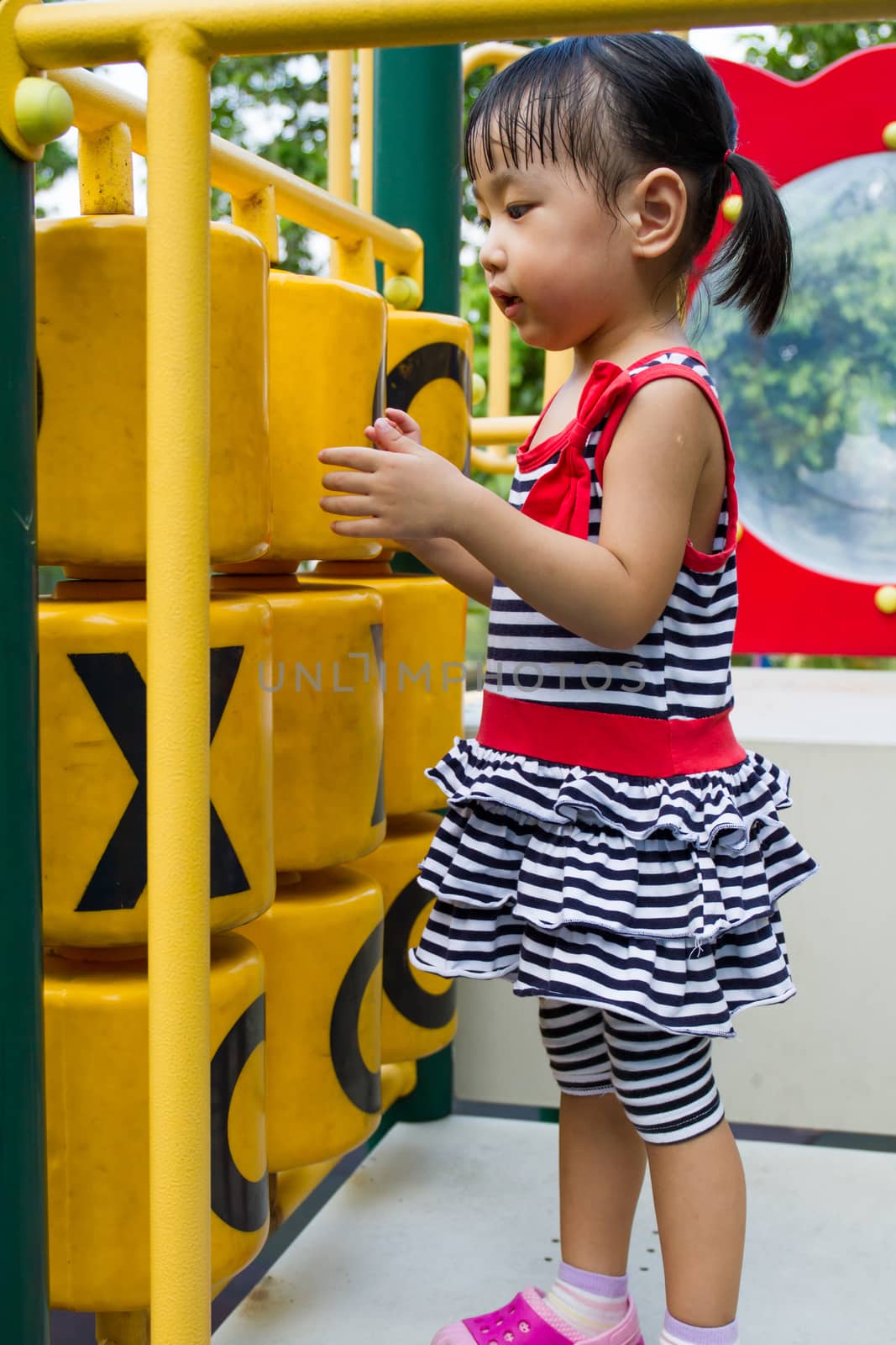 Asian Chinese little girl playing on Playground