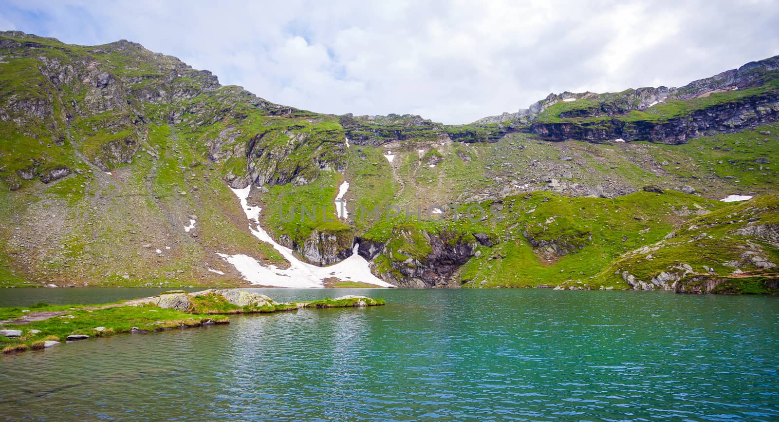 Idyllic view of Balea Lake shore in Fagaras Mountains, Romania.