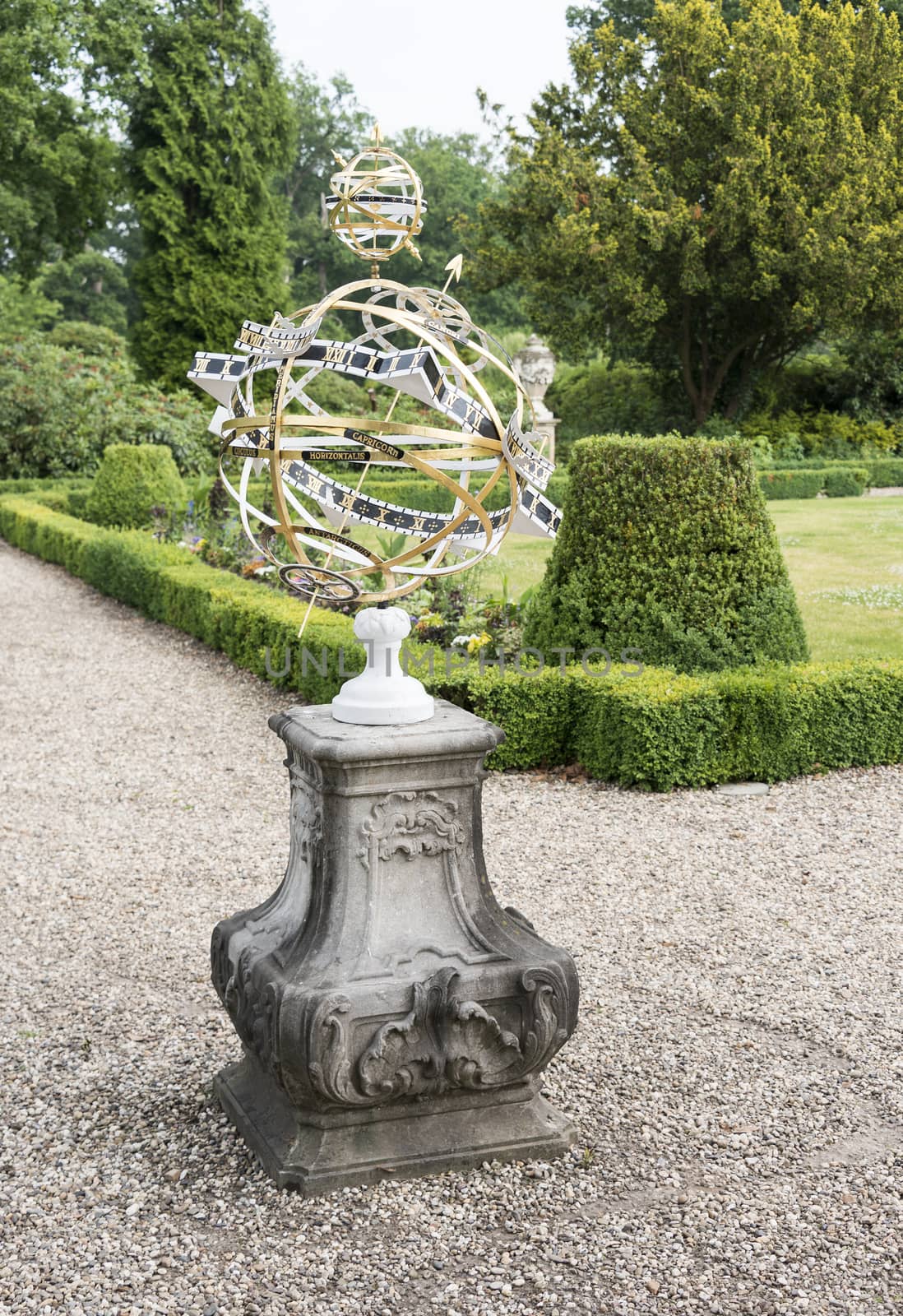 big metal sundial in english garden