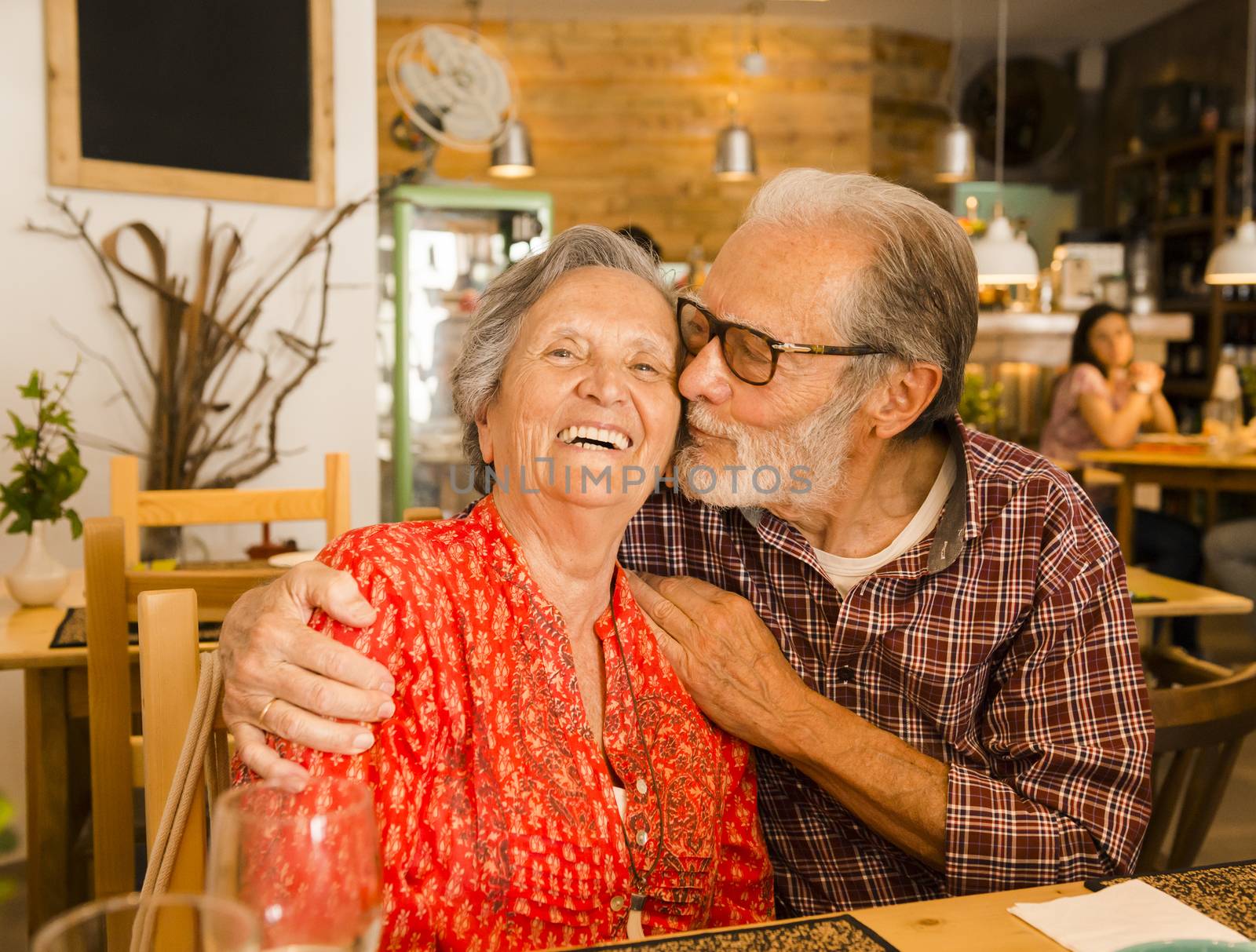 Old couple at the restaurant by Iko