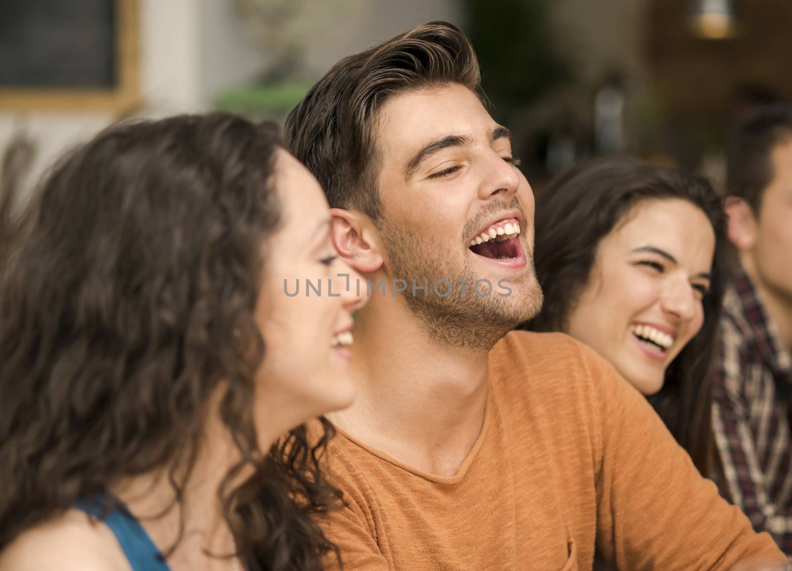 Multi-Ethnic Group of happy friends having fun at the restaurant