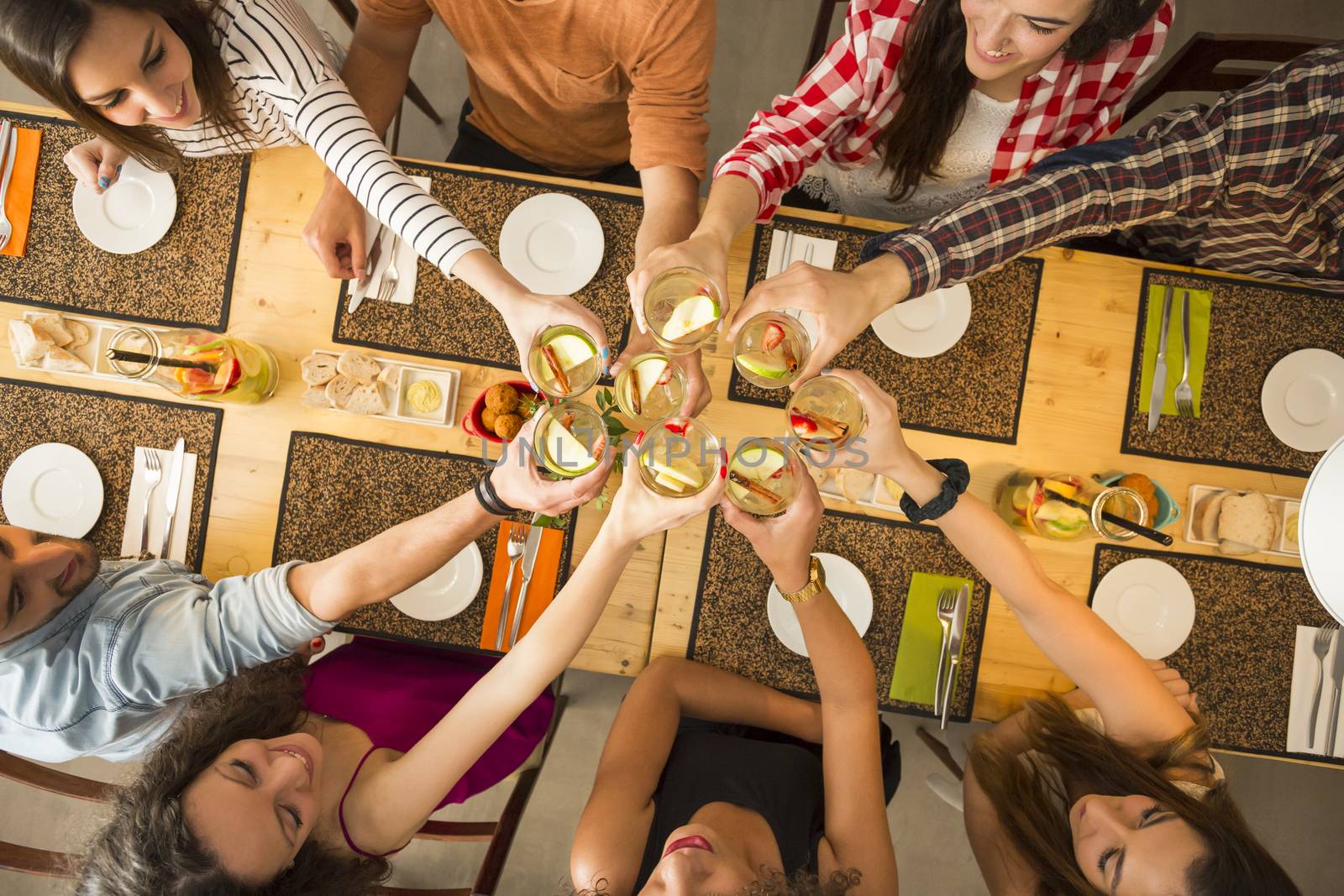 Group of people toasting and looking happy at a restaurant