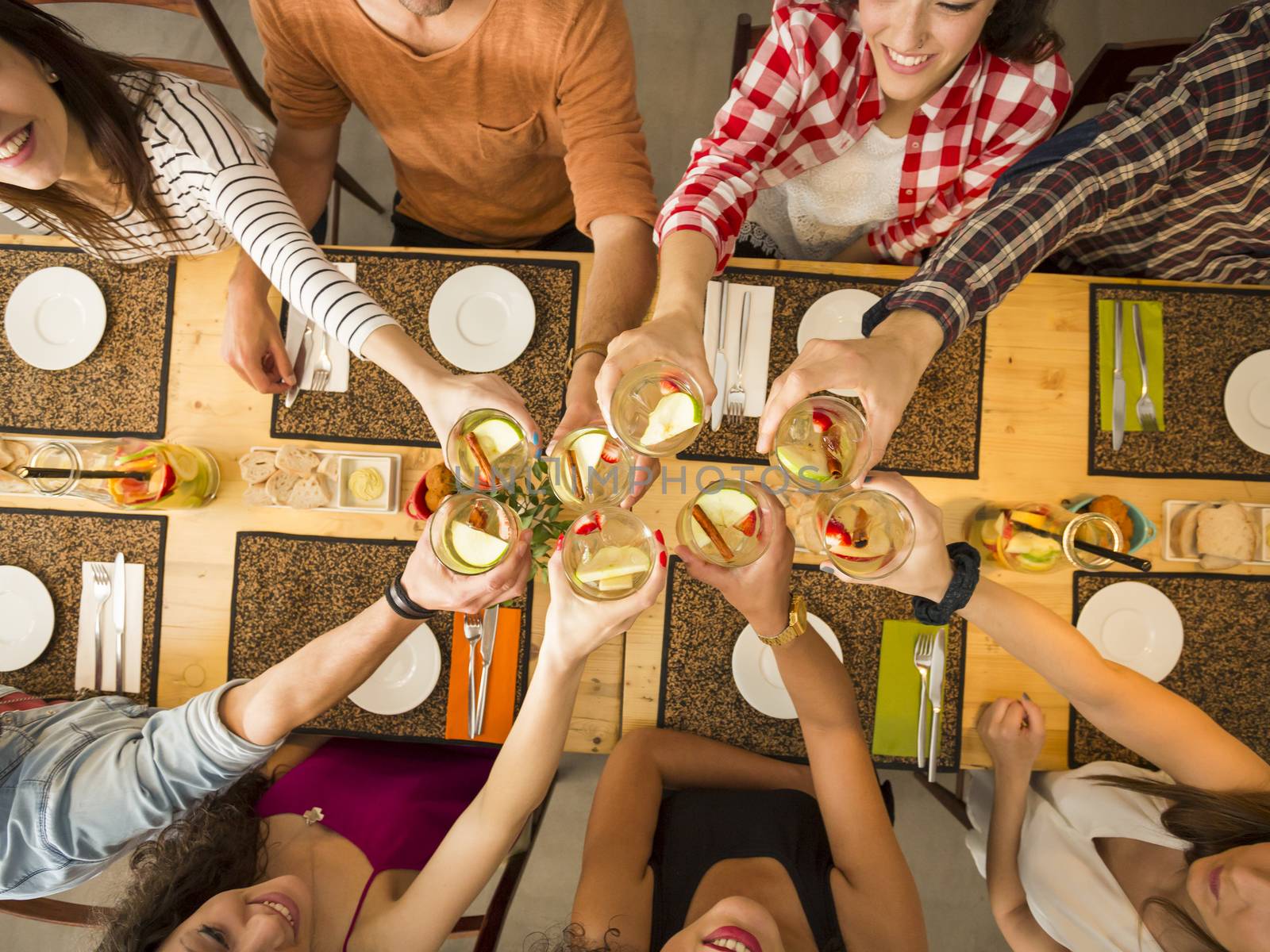 Group of people toasting and looking happy at a restaurant