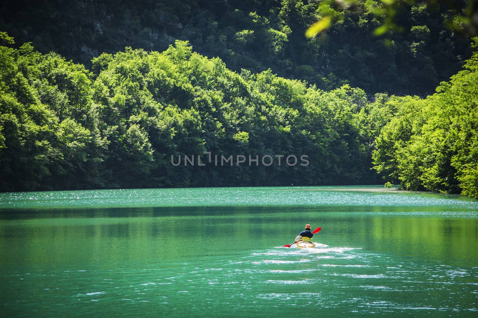 Adventurer Kayaking at the Tranquil Lake Alone by artofphoto