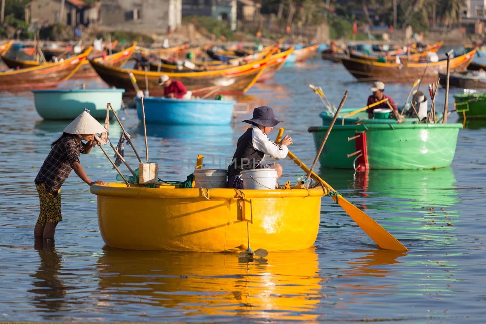 MUI NE, VIETNAM - FEBRUARY 08, 2014: Fishermen at work near Mui Ne - an upcoming touristic area in Southern Vietnam