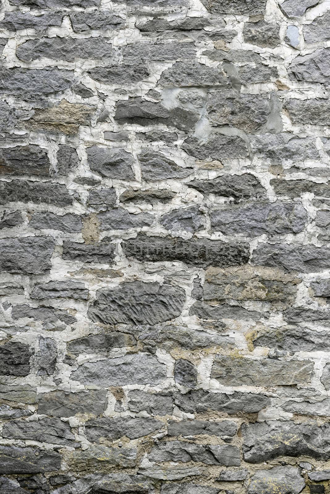 Vertical gray stone wall.  Extremely old