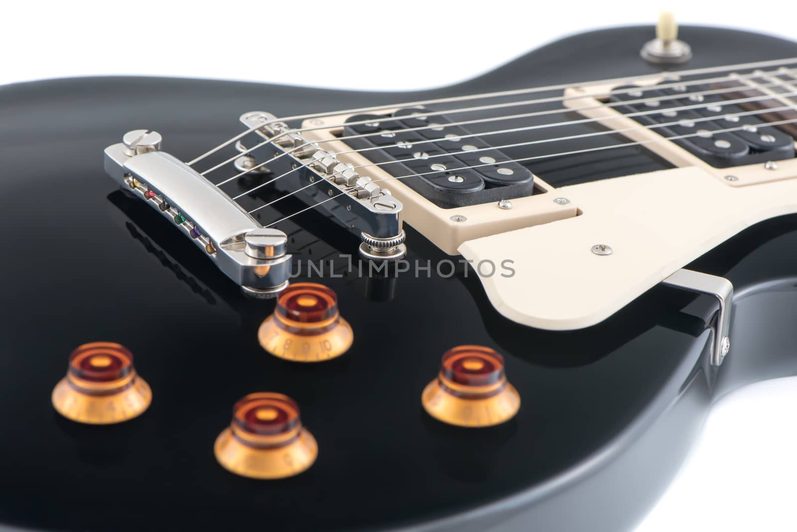 Detail of Black Electric Guitar Body with Strings Isolated on White Background