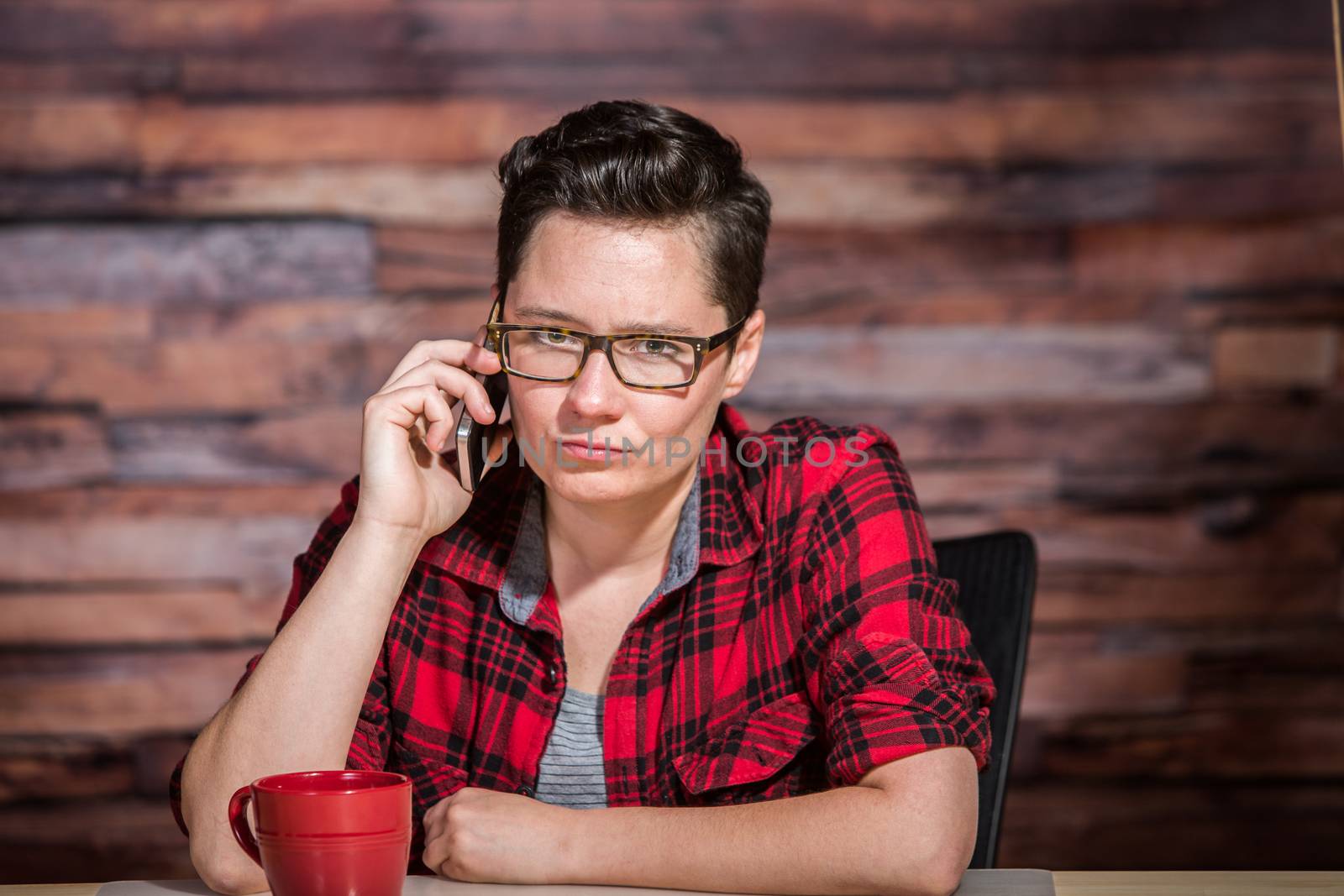 Grumpty woman on the phone in hipster office