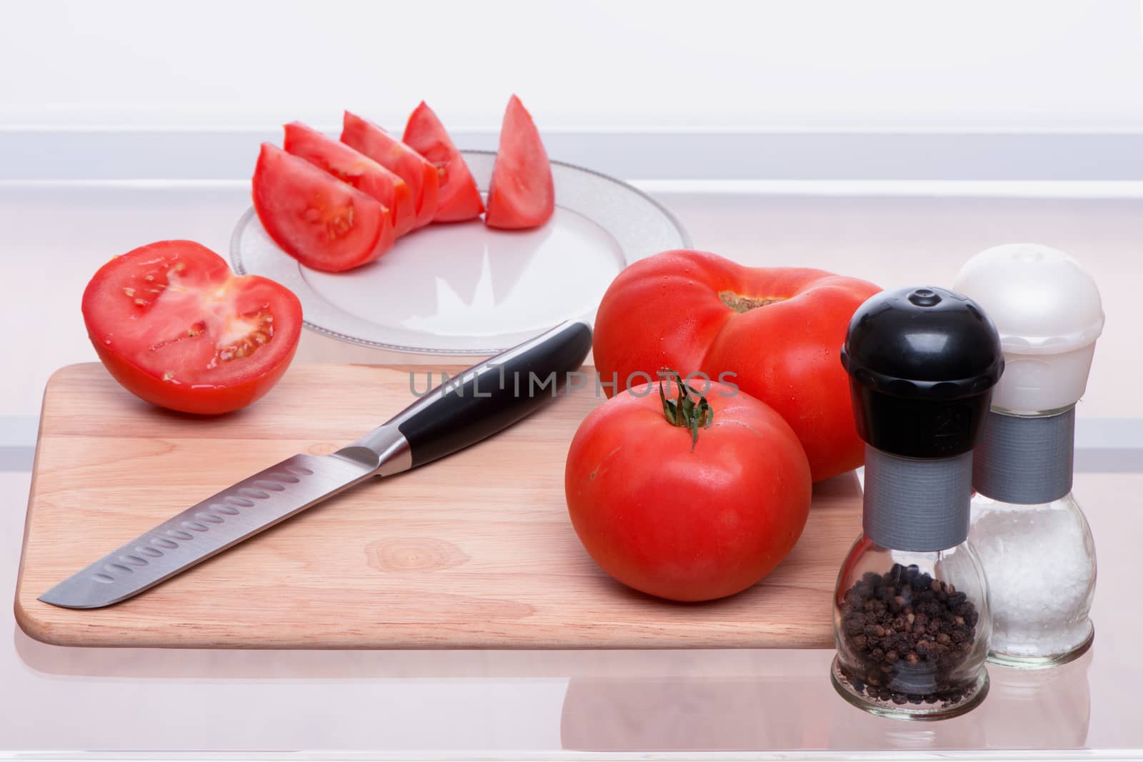 Tomatoes are sliced and salted also by pepper