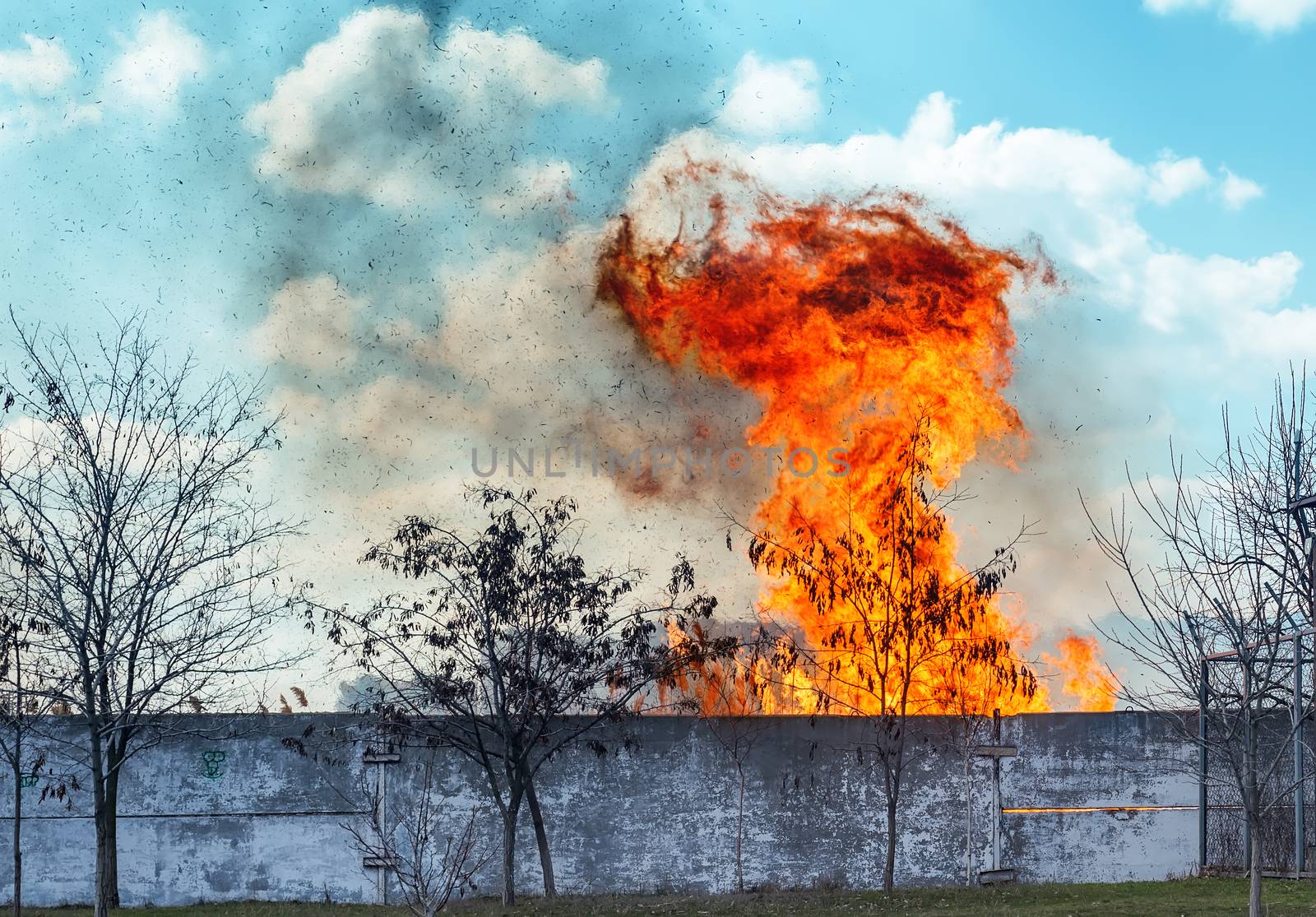 red fire with smog under clouds