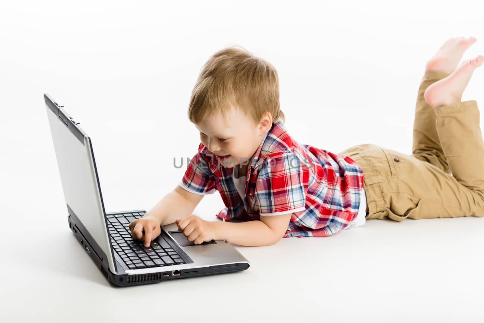 The little boy with a laptop. studio