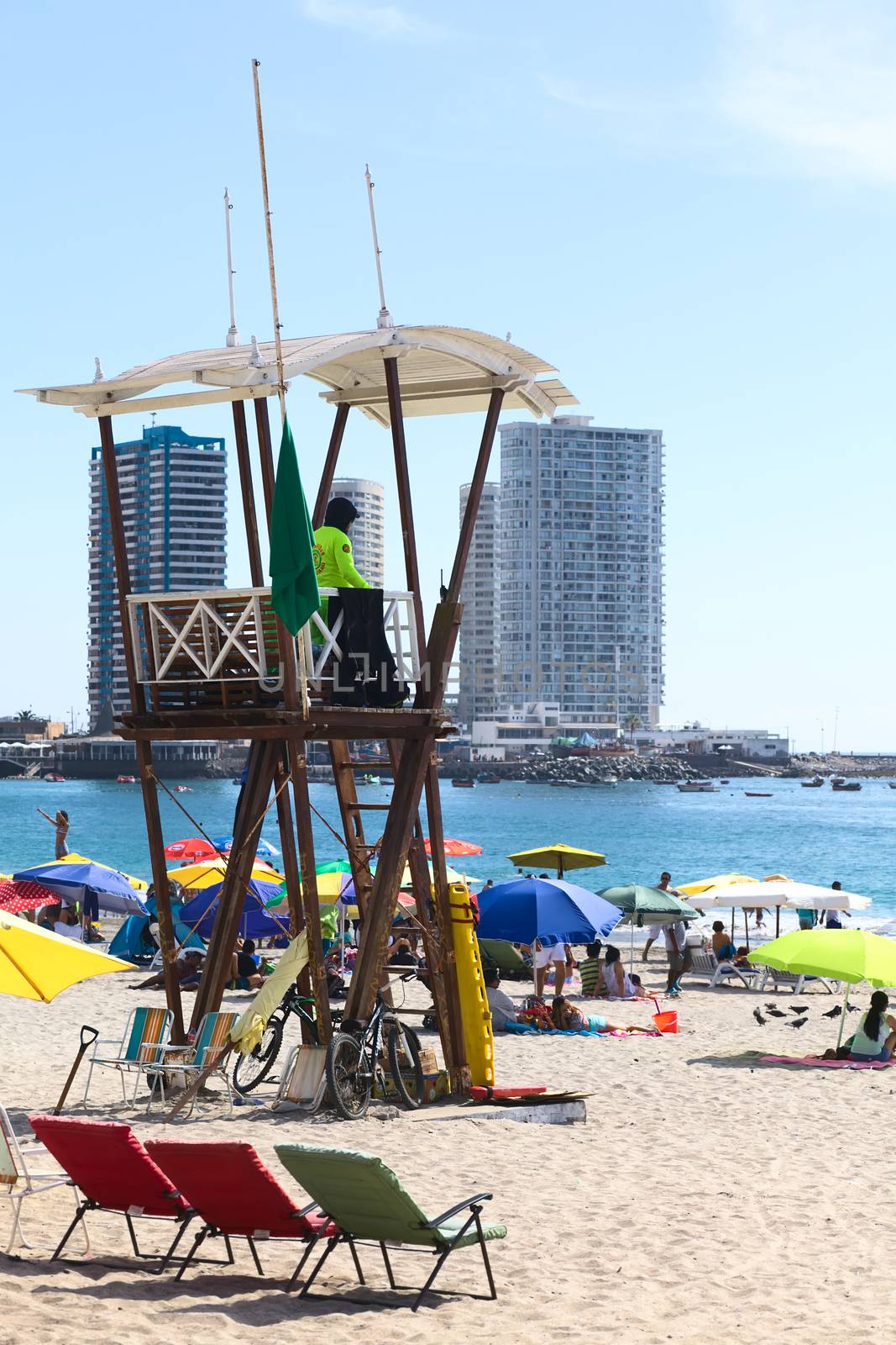 IQUIQUE, CHILE - JANUARY 23, 2015: Unidentified person in lifeguard watchtower on Cavancha beach on January 23, 2015 in Iquique, Chile. Iquique is a popular beach town and free port city in Northern Chile.