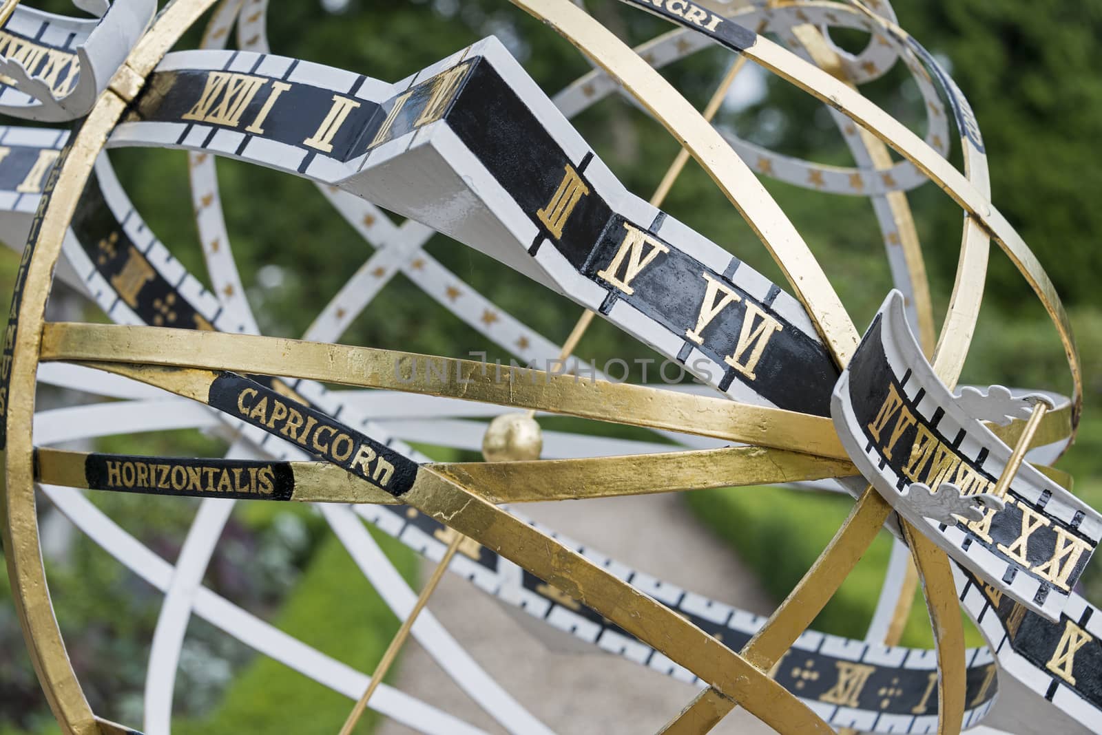 close up of sundial from golden metal and black fields
