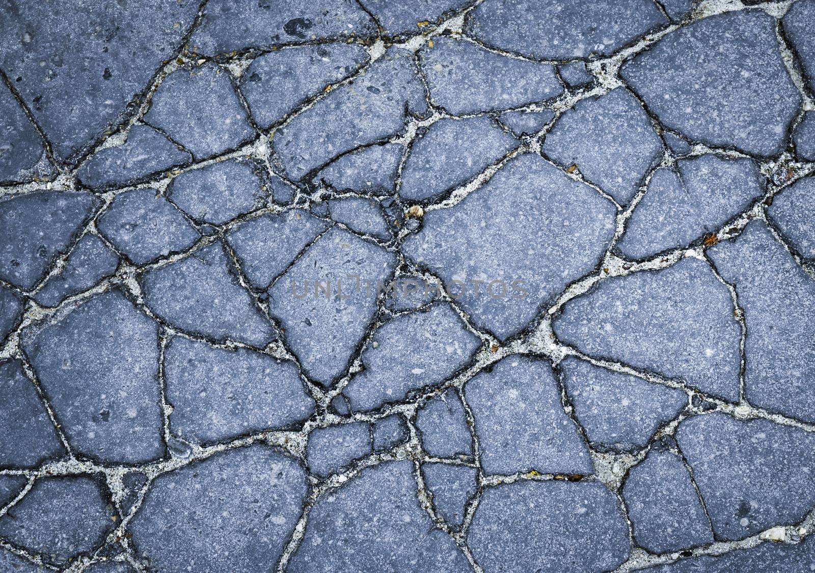 abstract background or texture asphalt pavement cracks broken