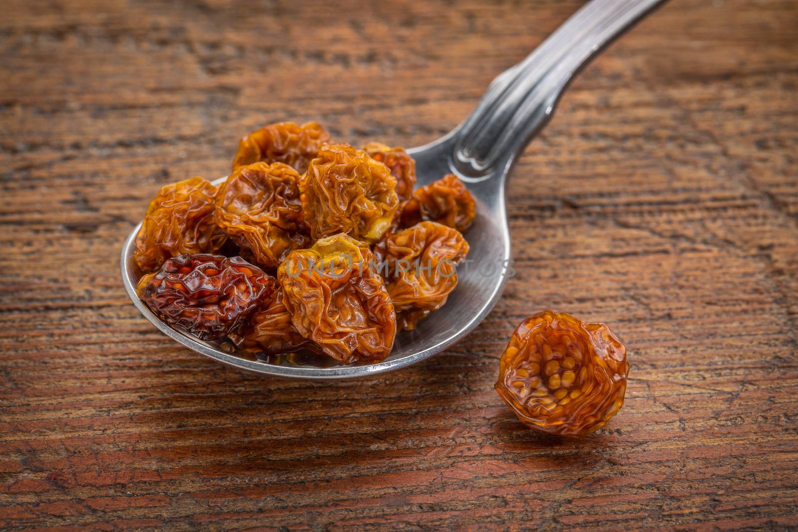 dried goldenberries on tablespoon by PixelsAway
