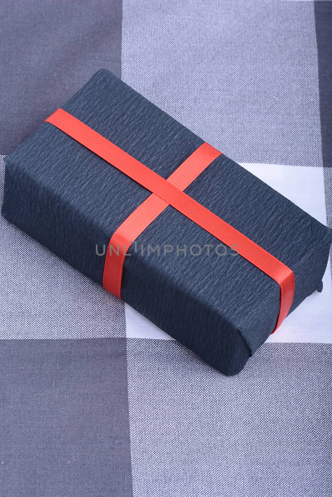 Black gift box with red ribbon by fotoscool