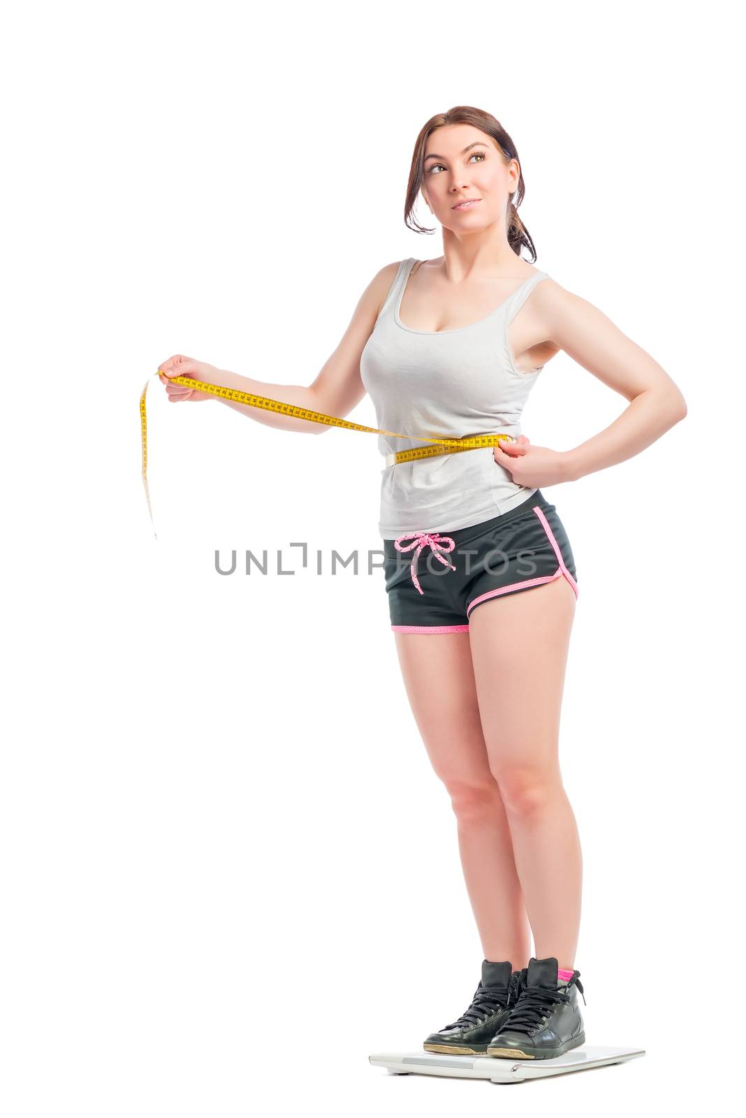 woman on scales measuring waist centimeter