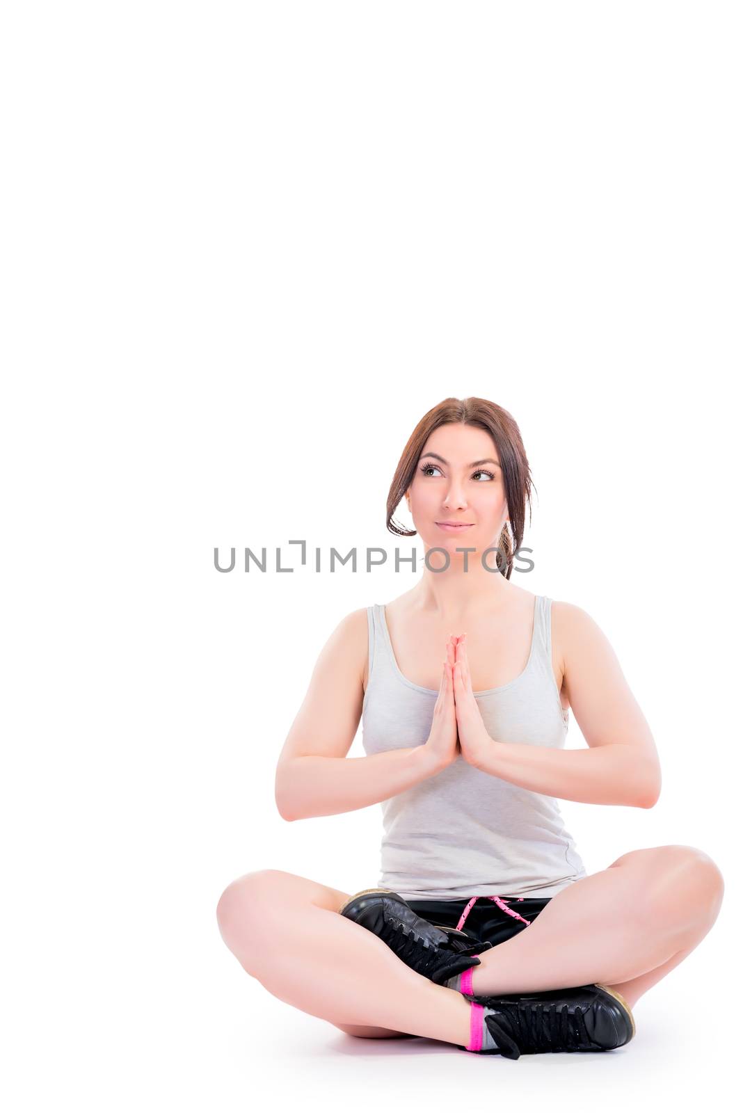 Vertical girl photo in lotus position on a white background
