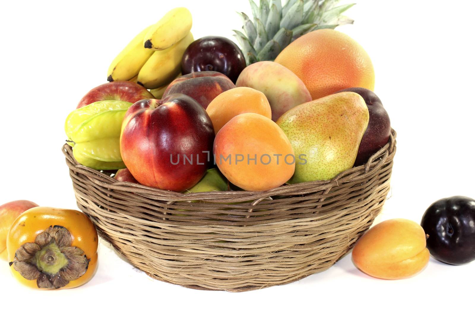 Fruit basket with various colorful fruits on a light background