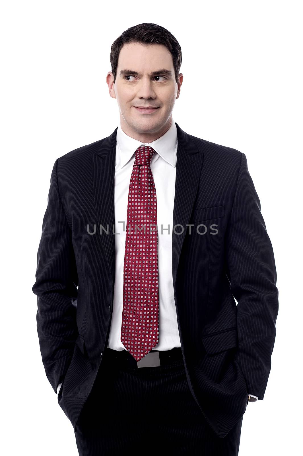 Confident businessman looking away by stockyimages