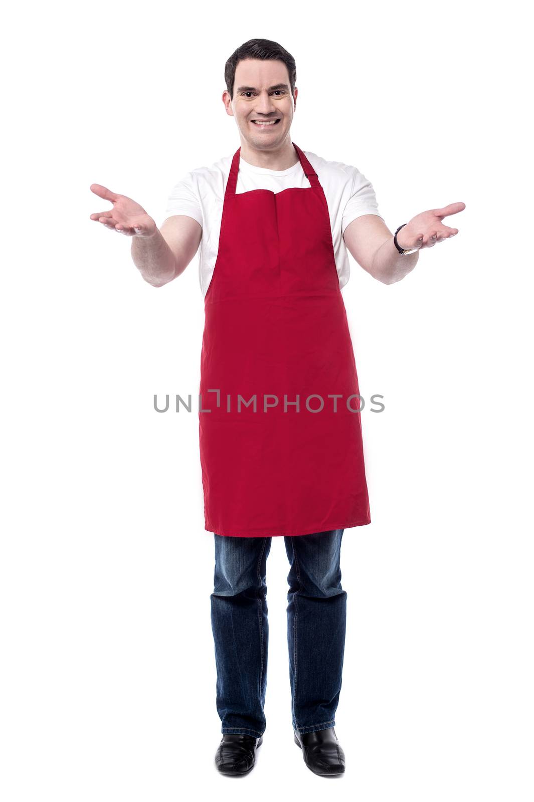 Full length of happy male chef with wide open arms. 