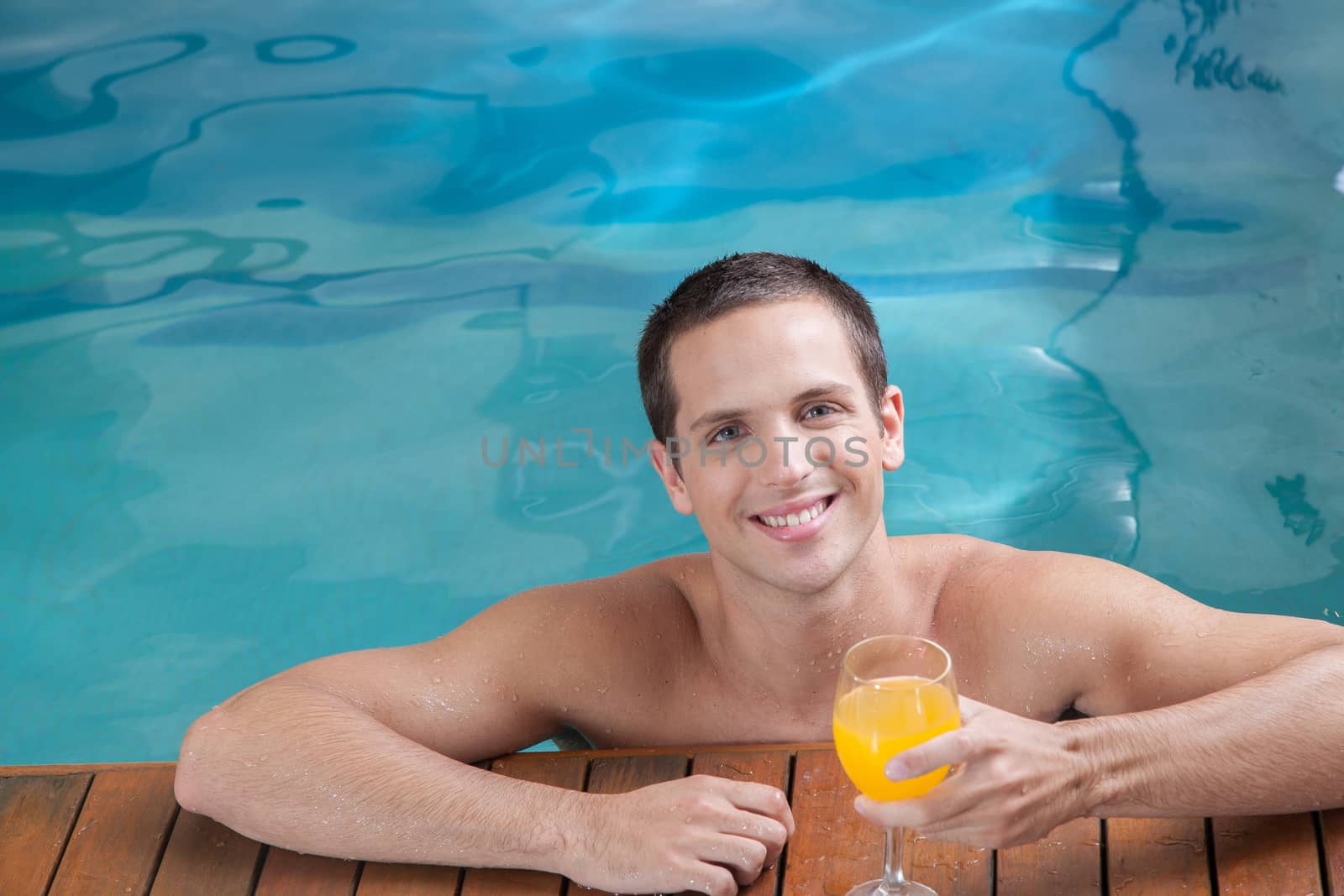 Man drinking juice inside the pool by ifilms