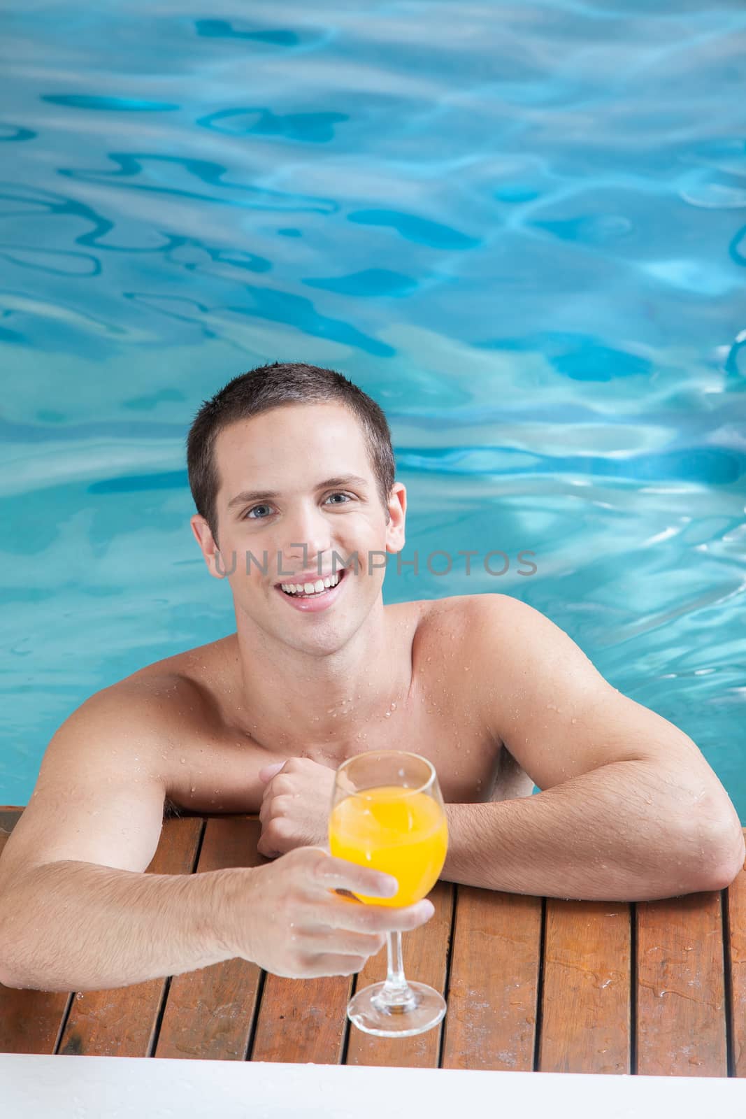 Man drinking juice inside the pool