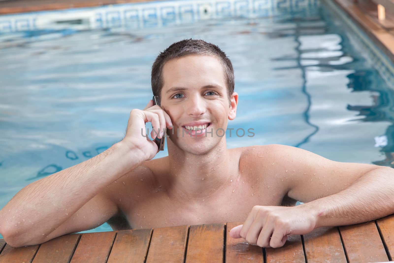 Man talking on cell inside the pool