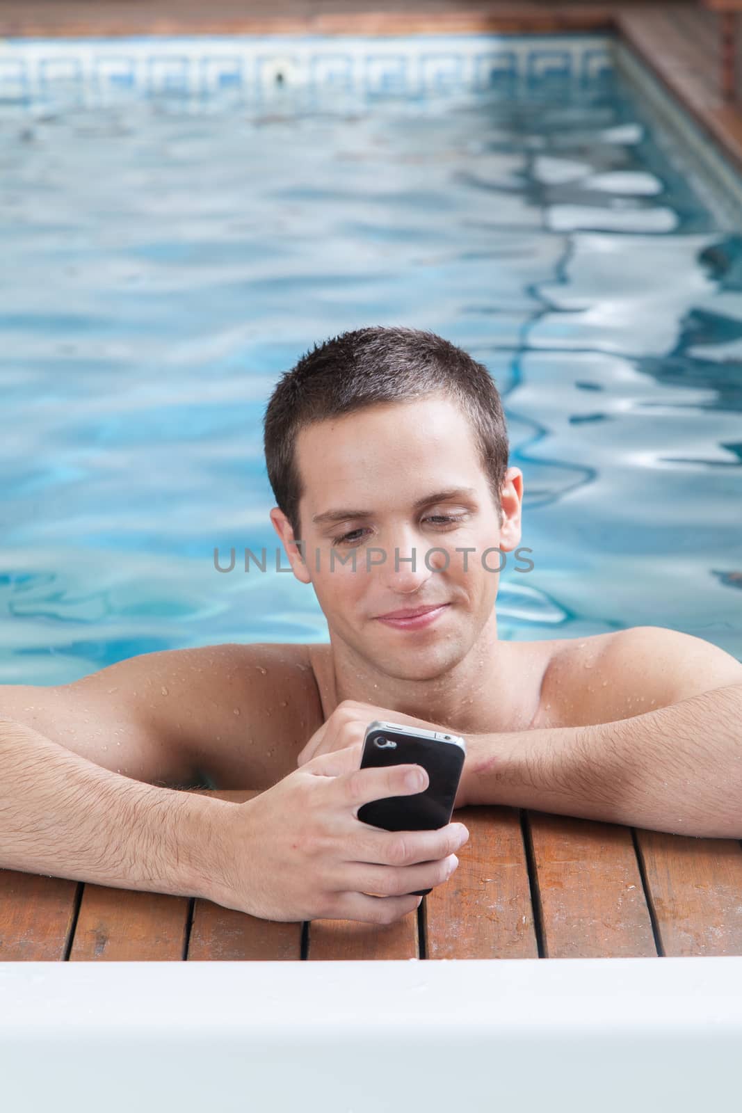 Man play with cell in a pool