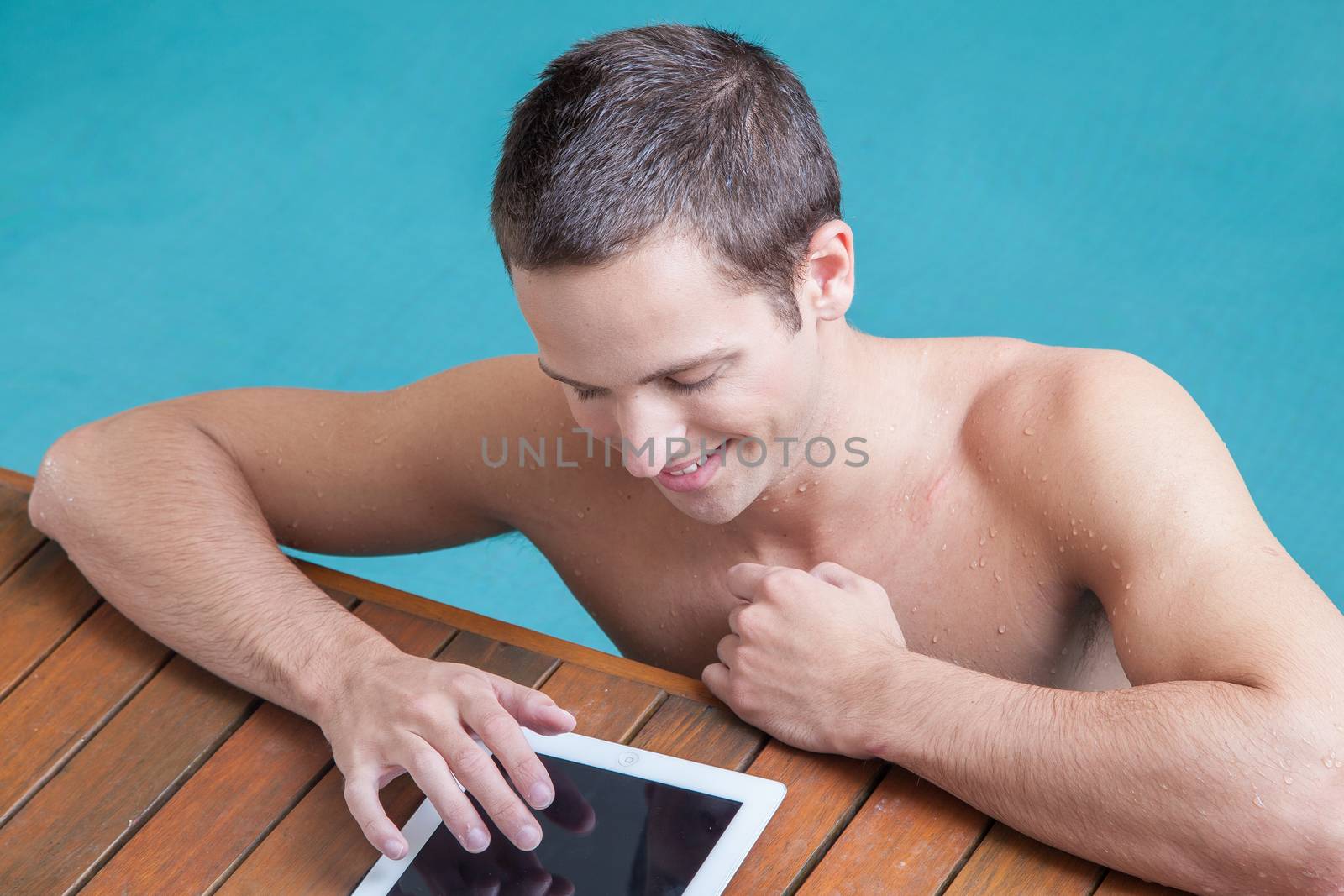 Man sending a message in the edege of the pool