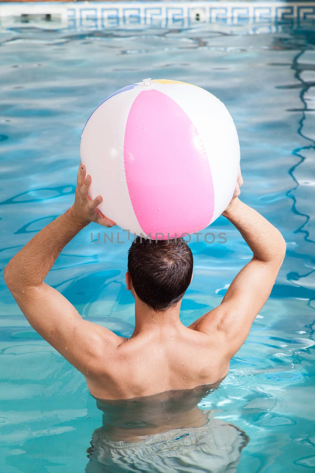 Man back playing with a inflatable ball by ifilms