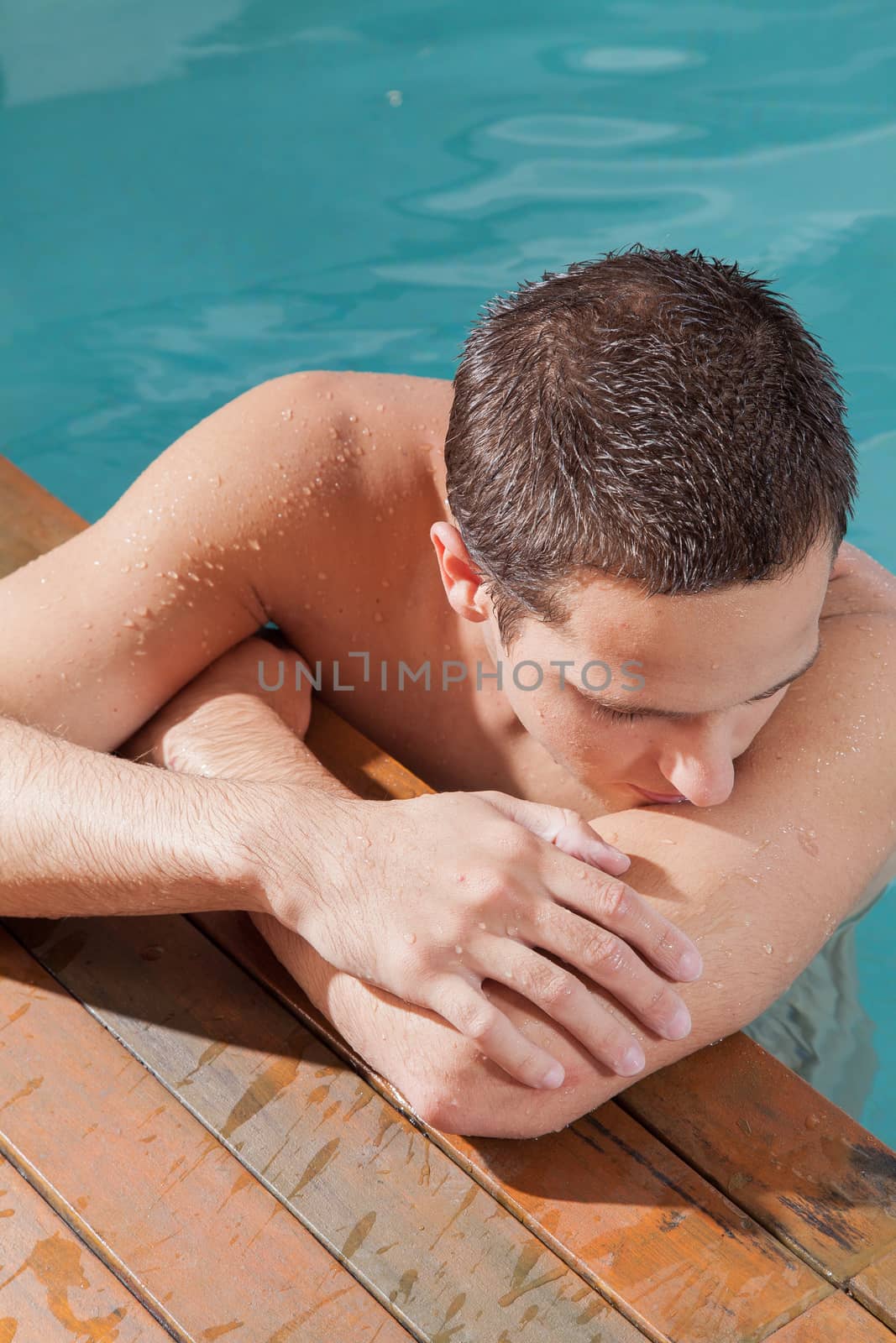 Man rest in the edge of the pool by ifilms