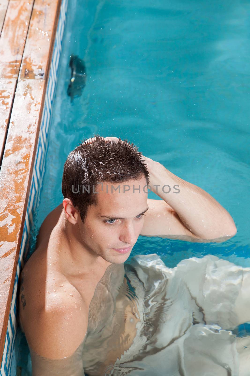 Man resting in the pool by ifilms